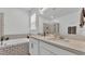 Bright bathroom features a double vanity with stone counters, soaking tub and tiled shower at 1725 Hill Top Dr, Dundee, FL 33838