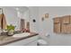 Neutral bathroom offers a modern sink, toilet and walk-in shower behind a door at 1725 Hill Top Dr, Dundee, FL 33838
