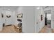 Inviting front foyer with bench seating, tiled floors and a view to an office space at 1725 Hill Top Dr, Dundee, FL 33838