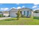 Charming single-story home with manicured lawn and beautiful landscaping enhances curb appeal at 1725 Hill Top Dr, Dundee, FL 33838
