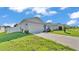 Well-kept house with a two-car garage and green lawn showcasing suburban living at 1725 Hill Top Dr, Dundee, FL 33838