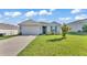 Charming single-story home with a well-maintained lawn and attached two-car garage at 1725 Hill Top Dr, Dundee, FL 33838