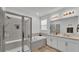 Elegant main bathroom featuring a glass shower, soaking tub, and double sink vanity at 1725 Hill Top Dr, Dundee, FL 33838