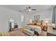 Bright and airy main bedroom featuring a ceiling fan and ensuite bath at 1725 Hill Top Dr, Dundee, FL 33838