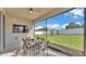 Relaxing screened porch features a TV and dining set for outdoor entertainment at 1725 Hill Top Dr, Dundee, FL 33838