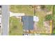 Aerial view of a home with a dark gray roof, a fenced yard and a long driveway at 1728 Bush Ave, Lakeland, FL 33805