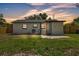 The backyard features a small concrete patio, privacy fence, and an exterior door at 1728 Bush Ave, Lakeland, FL 33805