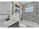 Modern bathroom featuring marble-patterned tile, a sleek vanity, and a shower-tub combination at 1728 Bush Ave, Lakeland, FL 33805