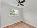 Minimalist bedroom with hardwood floors, a window providing natural light, and a ceiling fan at 1728 Bush Ave, Lakeland, FL 33805