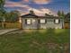 Charming single-story home with a well-manicured lawn and a newly installed wooden fence at 1728 Bush Ave, Lakeland, FL 33805