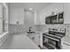 Contemporary kitchen with white cabinets, subway tile backsplash, stainless steel appliances, and quartz countertops at 1728 Bush Ave, Lakeland, FL 33805