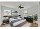 Serene main bedroom with modern decor, ample natural light, ceiling fan, and neutral color palette at 1728 Bush Ave, Lakeland, FL 33805