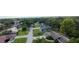 An aerial view shows residences nestled amongst mature trees and green landscaping at 1920 Indian Trails Ct, Lakeland, FL 33813