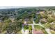 A picturesque aerial view showcases a charming home surrounded by lush greenery and mature trees at 1920 Indian Trails Ct, Lakeland, FL 33813