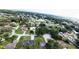 An aerial view shows residences in a verdant residential neighborhood dotted with mature trees and landscaping at 1920 Indian Trails Ct, Lakeland, FL 33813