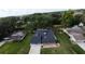 Aerial view of a single-Gathering home featuring a well-maintained lawn and mature trees at 1920 Indian Trails Ct, Lakeland, FL 33813