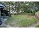 Large, shaded backyard featuring a fenced perimeter, screened porch, and mature shade trees at 1920 Indian Trails Ct, Lakeland, FL 33813