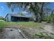 Expansive backyard featuring mature trees, a screened in porch, and ample green space at 1920 Indian Trails Ct, Lakeland, FL 33813