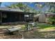 Backyard view featuring screened in patio, storage shed, and room to relax and entertain at 1920 Indian Trails Ct, Lakeland, FL 33813