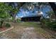Spacious backyard offering mature landscaping and a screened-in porch, perfect for outdoor relaxation at 1920 Indian Trails Ct, Lakeland, FL 33813