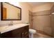 Bathroom with updated vanity, commode, and walk-in shower at 1920 Indian Trails Ct, Lakeland, FL 33813