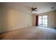 Spacious bedroom featuring a ceiling fan and sliding glass doors to the patio at 1920 Indian Trails Ct, Lakeland, FL 33813