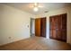 A carpeted bedroom featuring wood doors for the closet and ensuite at 1920 Indian Trails Ct, Lakeland, FL 33813
