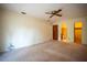 Neutral bedroom showcases a ceiling fan, closet, and adjacent bathroom for convenience at 1920 Indian Trails Ct, Lakeland, FL 33813