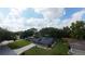 A charming one-story home with a blue exterior, well-manicured lawn, and mature trees at 1920 Indian Trails Ct, Lakeland, FL 33813