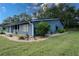 Charming one-story home featuring landscaped yard with decorative rock, mature plantings, and manicured lawn at 1920 Indian Trails Ct, Lakeland, FL 33813