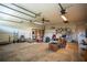 A spacious and cluttered garage with exposed beams and shelving units at 1920 Indian Trails Ct, Lakeland, FL 33813