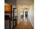 Inviting hallway with brick floors and natural light leading to the front door and featuring a charming fireplace at 1920 Indian Trails Ct, Lakeland, FL 33813