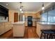 Well-lit kitchen featuring an island, granite countertops, stainless steel appliances, and light wood cabinets at 1920 Indian Trails Ct, Lakeland, FL 33813