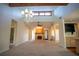 Cozy living room with a fireplace, wood beams, and a chandelier at 1920 Indian Trails Ct, Lakeland, FL 33813