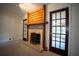 Comfortable living room showcases a fireplace with glass tile and French doors at 1920 Indian Trails Ct, Lakeland, FL 33813