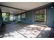 Spacious screened-in porch featuring ceiling fans and access to both the interior and the backyard at 1920 Indian Trails Ct, Lakeland, FL 33813
