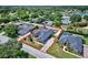 Aerial view of the house within a well-maintained neighborhood and surrounded by lush greenery at 2032 Indian Sky Cir, Lakeland, FL 33813