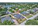 Aerial view of home with a screened pool and fenced yard, situated near a lake and green spaces at 2032 Indian Sky Cir, Lakeland, FL 33813