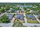 Neighborhood aerial view of a home with pool and large yard in a lush, treed neighborhood at 2032 Indian Sky Cir, Lakeland, FL 33813
