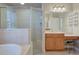 Bright bathroom features a glass shower, soaking tub, vanity, and a makeup area at 2032 Indian Sky Cir, Lakeland, FL 33813
