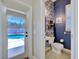 Cozy powder room with bright wallpaper and access to the pool at 2032 Indian Sky Cir, Lakeland, FL 33813