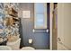Charming powder room with bright wallpaper, wooden accents, and a tiled shower at 2032 Indian Sky Cir, Lakeland, FL 33813