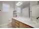 Bright bathroom featuring a double sink vanity, large mirror, and natural light from the window at 2032 Indian Sky Cir, Lakeland, FL 33813