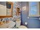 Charming powder room with bright wallpaper and wooden accents at 2032 Indian Sky Cir, Lakeland, FL 33813