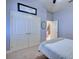 Simple bedroom with a closet, small mirror, and doorway to the kitchen at 2032 Indian Sky Cir, Lakeland, FL 33813