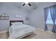 Neutral bedroom with a ceiling fan, window with curtains, and simple decor at 2032 Indian Sky Cir, Lakeland, FL 33813