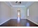 Spacious bedroom with tray ceilings, hardwood floors, and a view of the bath at 2032 Indian Sky Cir, Lakeland, FL 33813