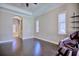 Bright bedroom with tray ceilings, hardwood floors, and a view of the bathroom at 2032 Indian Sky Cir, Lakeland, FL 33813