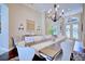 Dining room with a wooden table, chandelier, and decor, flowing into the home's entryway at 2032 Indian Sky Cir, Lakeland, FL 33813