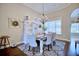 Dining room showcasing a chandelier, large window, white display cabinet, and elegant decor at 2032 Indian Sky Cir, Lakeland, FL 33813